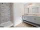 Elegant bathroom showcasing a double vanity with marble countertops and a glass-enclosed shower at 653 Locust Rd, Locust Grove, GA 30248