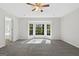 Bright bedroom with a ceiling fan, neutral carpet and a large window with nature views at 653 Locust Rd, Locust Grove, GA 30248