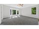 Spacious bedroom featuring neutral carpet, ceiling fan, and large windows offering ample natural light at 653 Locust Rd, Locust Grove, GA 30248