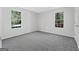 Comfortable bedroom with soft carpet, bright windows with nature views, and white trim at 653 Locust Rd, Locust Grove, GA 30248