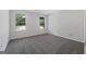 Inviting bedroom with natural light, wall-to-wall carpet, and bright white trim at 653 Locust Rd, Locust Grove, GA 30248
