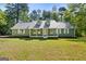 Inviting one-story home boasts a covered front porch, dormer windows, and ample natural light at 653 Locust Rd, Locust Grove, GA 30248