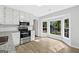 Bright kitchen with stainless steel appliances and eat-in nook with a bay window at 653 Locust Rd, Locust Grove, GA 30248