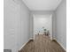Bright laundry room with wood-look flooring, white walls and trim, and modern appliances at 653 Locust Rd, Locust Grove, GA 30248