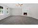 Bright living room featuring a white fireplace and large windows at 653 Locust Rd, Locust Grove, GA 30248