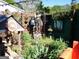 Unique backyard decor featuring wooden fence, shrubs, full sized knight, and a fairy house at 120 South Ave, Jonesboro, GA 30236