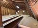 Unfinished attic offers natural light through two windows, showcasing exposed rafters and ample space for future customization at 183 Busbin Rd, Fayetteville, GA 30215