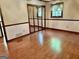 Bedroom with hardwood floors, mirrored closet doors, and natural light at 183 Busbin Rd, Fayetteville, GA 30215