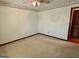 Bright bedroom with ceiling fan, neutral carpet, and floral wallpaper border at 183 Busbin Rd, Fayetteville, GA 30215