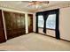 Bedroom boasts a ceiling fan, carpet, and dark wood closet doors at 183 Busbin Rd, Fayetteville, GA 30215
