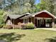 A side view of a brick single-story home with a carport and landscaped yard at 183 Busbin Rd, Fayetteville, GA 30215