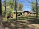 Charming single-story brick home with a well-manicured lawn and mature trees at 183 Busbin Rd, Fayetteville, GA 30215