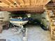 A spacious garage includes a boat on a trailer, lawn equipment, and additional storage under the exposed wood ceiling at 183 Busbin Rd, Fayetteville, GA 30215