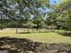 Beautiful acreage with green grass, large trees, and a fence bordering the property line at 183 Busbin Rd, Fayetteville, GA 30215