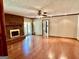Bright living room with hardwood floors, brick fireplace, and sliding door to deck at 183 Busbin Rd, Fayetteville, GA 30215
