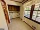 Pantry area off the kitchen with tile floors, cabinets, and shelving at 183 Busbin Rd, Fayetteville, GA 30215