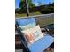 Inviting outdoor seating with decorative pillows adds charm to the cozy backyard deck at 1600 Prospect Pl, Locust Grove, GA 30248