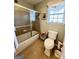 Bathroom featuring a shower over tub with tile floors and a window at 1600 Prospect Pl, Locust Grove, GA 30248