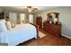 Bedroom with hardwood floors and a large wooden dresser at 1600 Prospect Pl, Locust Grove, GA 30248