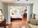 Inviting bedroom featuring hardwood floors and decor with a nice view of the ensuite bathroom at 1600 Prospect Pl, Locust Grove, GA 30248