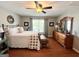 Bright bedroom with hardwood floors and a large window at 1600 Prospect Pl, Locust Grove, GA 30248