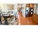 Open concept dining area with hardwood flooring, stainless steel appliances, and a modern table set at 1600 Prospect Pl, Locust Grove, GA 30248