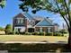 Charming two-story brick home with a manicured lawn and patriotic flag display at 1600 Prospect Pl, Locust Grove, GA 30248