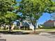View of a charming two-story house nestled behind mature trees, highlighting a tranquil setting at 1600 Prospect Pl, Locust Grove, GA 30248