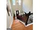 Stairway view of a spacious foyer with hardwood floors and a chandelier at 1600 Prospect Pl, Locust Grove, GA 30248