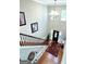 Second story view of a foyer with hardwood floors, rug, and high ceilings at 1600 Prospect Pl, Locust Grove, GA 30248