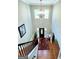 Second story view of a foyer with hardwood floors, rug, and high ceilings at 1600 Prospect Pl, Locust Grove, GA 30248