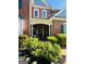 Charming front entrance with brick facade and manicured flower beds at 1600 Prospect Pl, Locust Grove, GA 30248