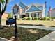 Charming brick and blue two-story home with well-manicured lawn and a classic mailbox at 1600 Prospect Pl, Locust Grove, GA 30248