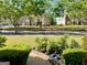 Scenic front yard with lush green grass, neatly trimmed hedges, and mature trees providing ample shade at 1600 Prospect Pl, Locust Grove, GA 30248