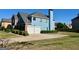Light blue two-story home with a two-car garage and a green lawn at 1600 Prospect Pl, Locust Grove, GA 30248