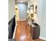 Hallway with decorative table, mirror, and hardwood floors at 1600 Prospect Pl, Locust Grove, GA 30248