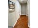 Hallway with hardwood flooring and bright white doors, baseboards, and trim at 1600 Prospect Pl, Locust Grove, GA 30248
