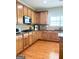 Functional kitchen with wood cabinets, stainless steel appliances, and tile backsplash at 1600 Prospect Pl, Locust Grove, GA 30248
