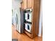 Stainless steel appliances, including refrigerator and built-in double ovens at 1600 Prospect Pl, Locust Grove, GA 30248