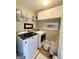 Functional laundry room with white cabinets, modern washer and dryer, and organized shelving at 1600 Prospect Pl, Locust Grove, GA 30248