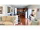 Spacious living room with hardwood floors, an open floorplan and kitchen in the background at 1600 Prospect Pl, Locust Grove, GA 30248