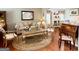 Well-decorated living room with a plush sofa, ornate coffee table, and elegant furnishings at 1600 Prospect Pl, Locust Grove, GA 30248