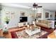 Cozy living room with hardwood floors, TV, and comfortable sofa seating at 1600 Prospect Pl, Locust Grove, GA 30248
