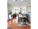 Open-concept living room connected to a dining area with hardwood floors at 1600 Prospect Pl, Locust Grove, GA 30248