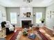 Bright living room featuring hardwood floors, fireplace, and large windows at 1600 Prospect Pl, Locust Grove, GA 30248