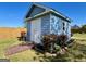 Outbuilding features a charming walkway, light blue siding and a new roof at 1600 Prospect Pl, Locust Grove, GA 30248