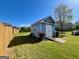 Outbuilding features a charming walkway, light blue siding and a new roof at 1600 Prospect Pl, Locust Grove, GA 30248