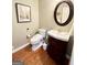 Well-lit powder room with a decorative mirror, modern vanity and a sleek toilet at 1600 Prospect Pl, Locust Grove, GA 30248