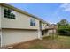 View of the home's back exterior, showcasing the deck and spacious yard at 8103 Rhodes Way, Riverdale, GA 30274
