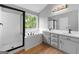 Bathroom featuring a glass-enclosed shower, soaking tub, double vanity with sleek black hardware at 8103 Rhodes Way, Riverdale, GA 30274